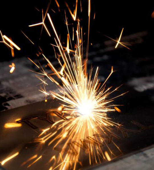 Up close image of a peice of metal being laser marked